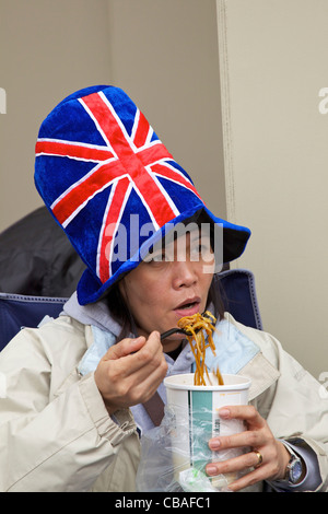 Foreign visitor enjoys noodles during marriage of Prince William to Kate Middleton, 29th April 2011, London, England, GB,