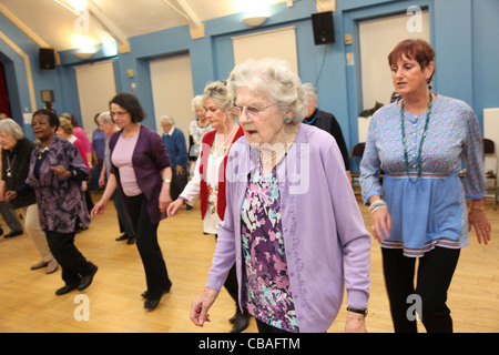 Women linedancing line dancing in a community hall Stock Photo