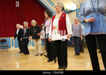 Women linedancing in a community hall Stock Photo