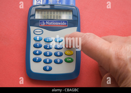Studio Elderly woman selecting a function to access her online banking account Stock Photo