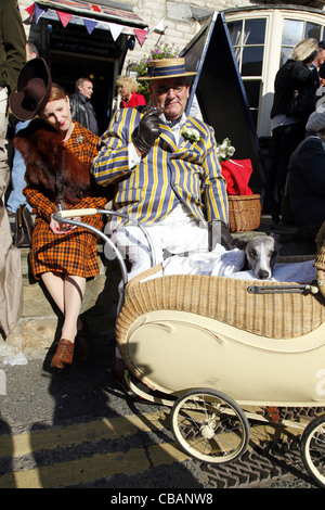 COUNTRY LADY & GENTLEMAN WITH WHIPPET IN PRAM PICKERING NORTH YORKSHIRE 15 October 2011 Stock Photo