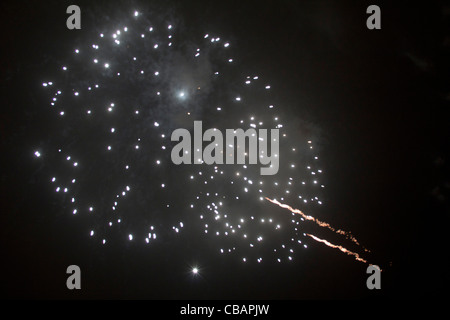 Beautiful fireworks display. Two huge white explosions with streaks of yellow light fill the night sky. London Stock Photo