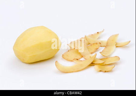 a single peeled potato with peel isolated on a white background Stock Photo