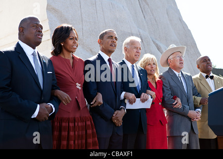President Barack Obama, First Lady Michelle Obama, Vice President Joe Biden and Dr. Jill Biden link arms and sing 'We Shall Overcome' during the dedication ceremony for the Martin Luther King Jr. National Memorial October 16, 2011 in Washington, DC. Joining them, from left, are: Harry Johnson, Sr.; Stock Photo