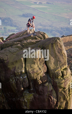 Rock Climber and Gritstone Edge, The Roaches, Peak District National Park near Leek, Staffordshire, UK Stock Photo