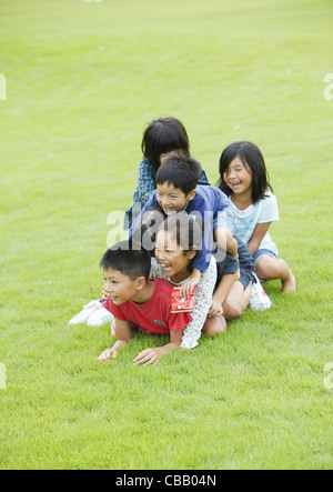 Children playing on grass Stock Photo