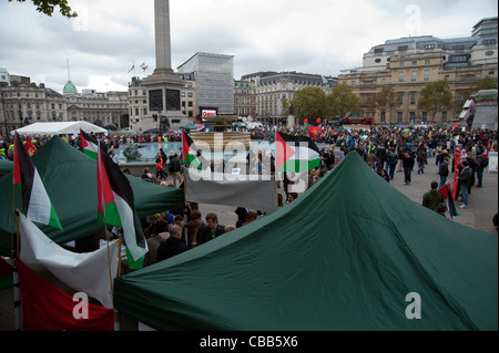 Protesters in Trafalgar Square, London, UK with Palestinian flags Stock Photo
