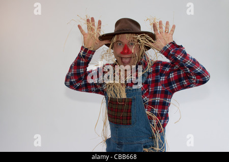 Human Scarecrow making faces or trying to scare off the crows. Stock Photo