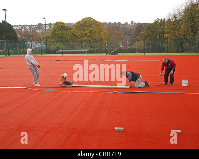 Construction of synthetic clay tennis courts - cutting in the white 'lines' into the stability base Stock Photo