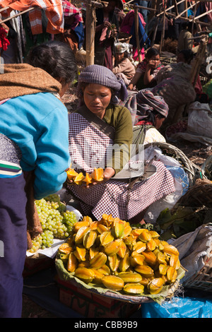 India, Meghalaya, Jaintia Hills, Shillong district, Ummulong Bazar, women, trader selling fresh starfruit Stock Photo