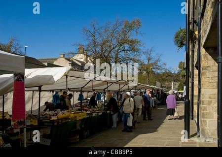 People browsing looking shopping at stalls Market Day on High Street Skipton North Yorkshire England UK United Kingdom GB Great Britain Stock Photo