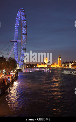 The London Eye, River Thames, Houses of Parliament and Big Ben photographed at night from Hungerford Bridge. Stock Photo