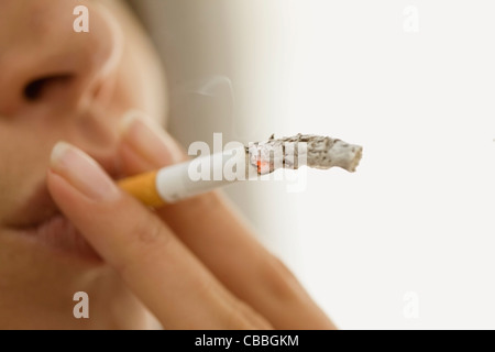 Close up of woman smoking cigarette Stock Photo