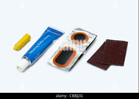 a puncture repair kit for a bicycle / cycle contents displayed on a white background Stock Photo