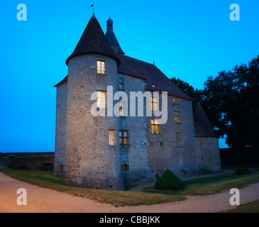 Stone house lit up at night Stock Photo