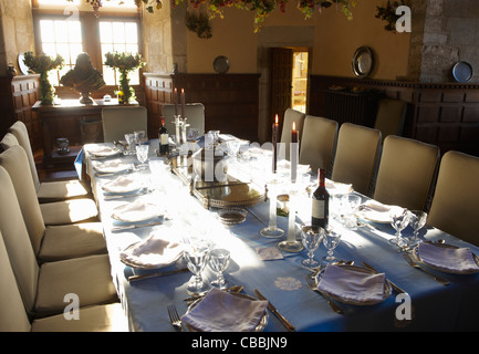 Ornate table settings in dining room Stock Photo