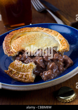 Steak and Ale Pie on blue plate Stock Photo