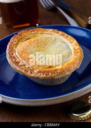 Steak and Ale Pie on blue plate Stock Photo