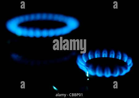 kitchen gas burning with blue flame isolated on black background Stock Photo