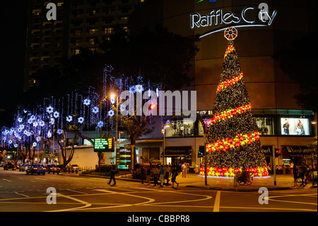 Christmas tree and lights in Singapore outside Raffles City Mall. Stock Photo