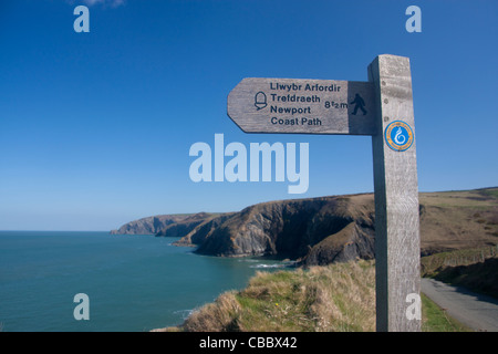 Wales Coast Path sign Cliffs and coastal scenery in background Ceibwr Bay North Pembrokeshire South West Wales UK Stock Photo