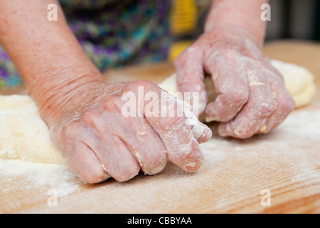 Close up of woman kneading dough Stock Photo