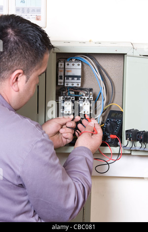 Electrician working on a panel Stock Photo