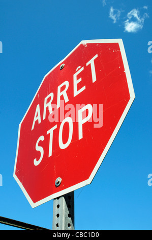 A bilingual STOP sign in Quebec, known colloquially as 'un arret-stop' Stock Photo