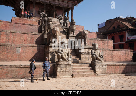 Nepali police standing guard at Nyatapola Temple - Bhaktapur, Kathmandu Valley, Nepal Stock Photo