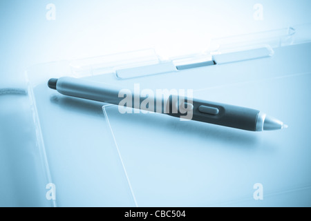 Graphic tablet with pen with blue tint Stock Photo
