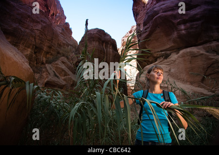 young girl hiking through the deep and narrow canyon Stock Photo