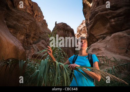 young girl hiking through the deep and narrow canyon Stock Photo