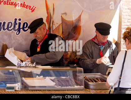 A market stall selling eels at a traditional costume market in the town of Veere - Walcheren, Zeeland, The Netherlands Stock Photo