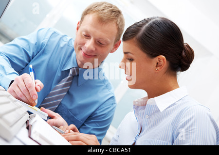 Manager showing plans to his female subordinate Stock Photo