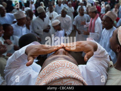 Man Kissing Blessing At The Crow During Maulidi Festival Celebration, Lamu, Kenya Stock Photo