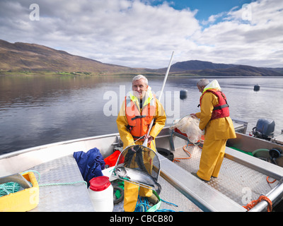 Fisherman holding salmon in net