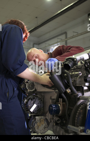 Teacher helping student with car engine Stock Photo