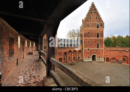 Worn-out red bricks in corridor and inner court of the medieval Beersel Castle, Belgium Stock Photo