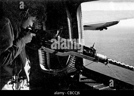 Gunne rmans his M2 Browning .50' machine gun in a WW11 USAAF Flying Fortress. Stock Photo