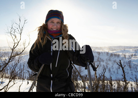 Smiling woman cross-country skiing Stock Photo