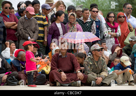 Pilgrims watching Cham dancers at the Phayang Tsedup Festival, Phayang Gompa, (Ladakh) Jammu & Kashmir, India Stock Photo