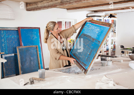 Designer with printing screen in studio Stock Photo