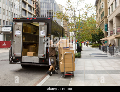 UPS delivery man unloading packages from truck - Washington, DC USA Stock Photo