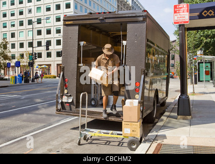UPS delivery man unloading packages from truck - Washington, DC USA Stock Photo