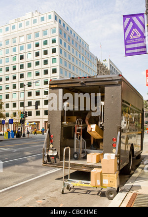 UPS delivery man unloading packages from truck Stock Photo