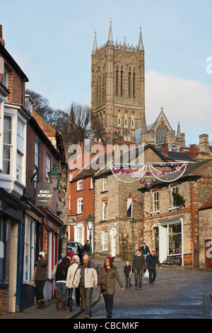 View up narrow cobbled street leading to uphill area with the cathedral. Steep Hill, Lincoln, Lincolnshire, England, UK. Stock Photo
