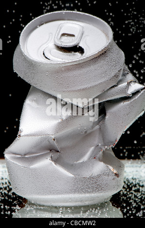 object on black - Crumpled beverage can Stock Photo