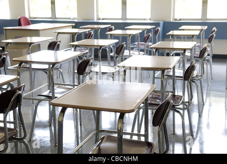 Desks in rows in an empty classroom Stock Photo