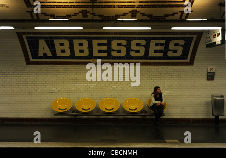 Female passenger waiting for train at metro station of Abbesses in Paris, France metro, subway, underground, sign, station, chai Stock Photo