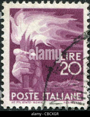 ITALY - CIRCA 1945: A stamp printed in Italy, shows a Torch, circa 1945 Stock Photo